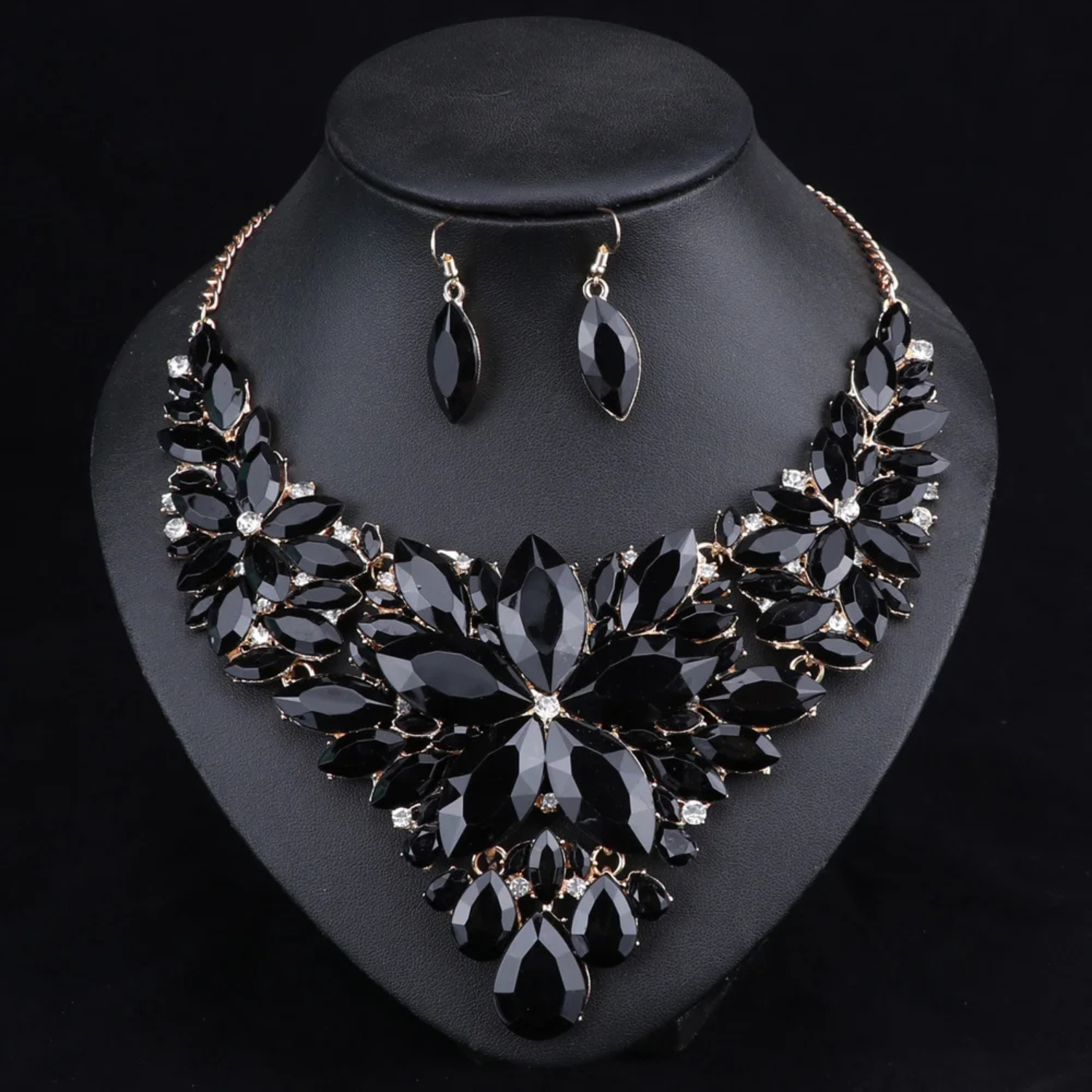 Elegant black crystal bridal jewelry set with floral statement necklace and matching earrings, perfect for weddings, parties, and formal occasions