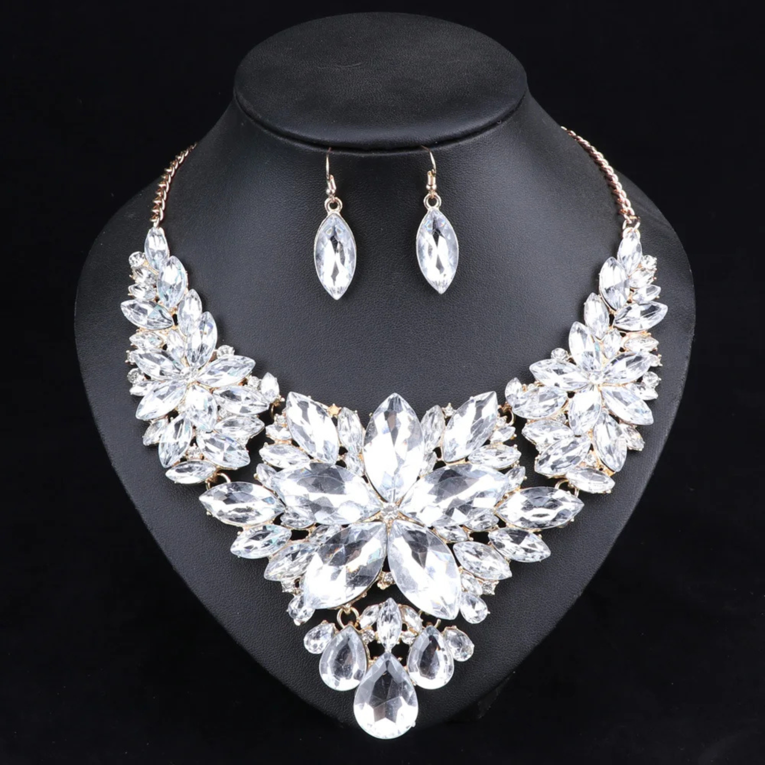 Elegant clear crystal bridal jewelry set with floral statement necklace and matching earrings, perfect for weddings, engagements, and formal occasions