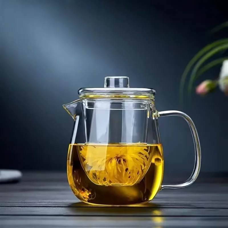Clear borosilicate glass teapot with infuser brewing blooming loose leaf tea, heat-resistant stovetop safe tea kettle