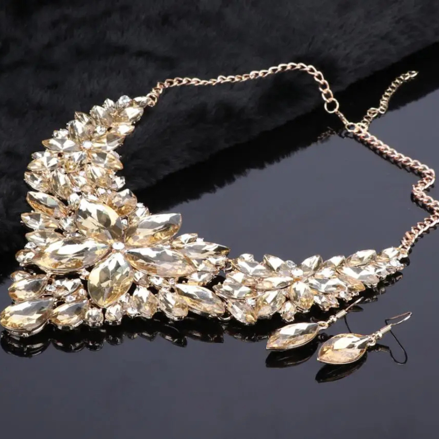 Elegant gold crystal bridal jewelry set with floral statement necklace and matching earrings, perfect for weddings, engagements, and formal occasions