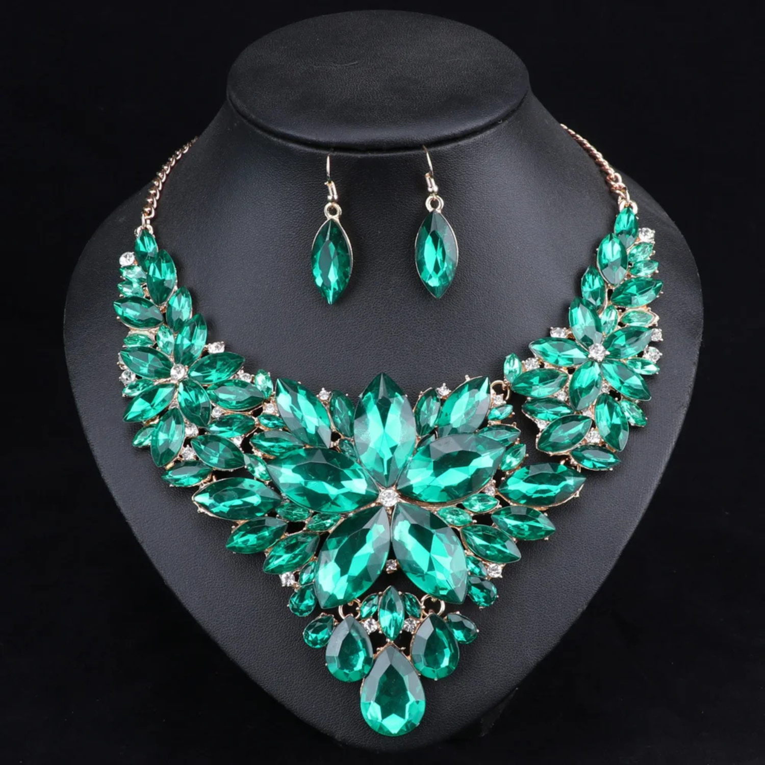 Elegant green crystal bridal jewelry set with floral statement necklace and matching earrings, ideal for weddings, engagements, and formal events