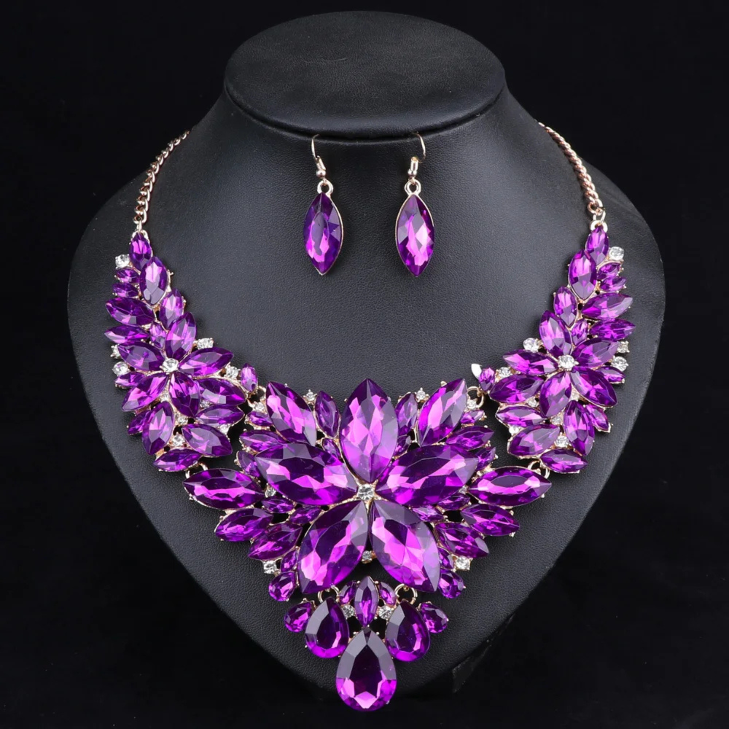Elegant purple crystal bridal jewelry set with floral statement necklace and matching earrings, ideal for weddings, engagements, and formal occasions